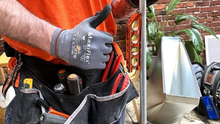 Person wearing gloves and an orange shirt holds a level tool while standing next to a tool belt filled with various tools; plants and metal objects are in the background. Evergreen State Heat & AC